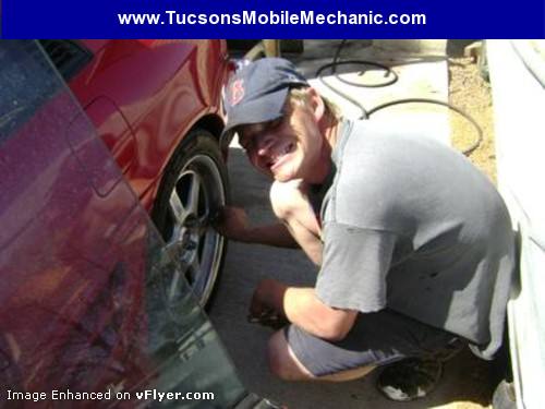 Robert Kious repairing a car on-site at a wheel