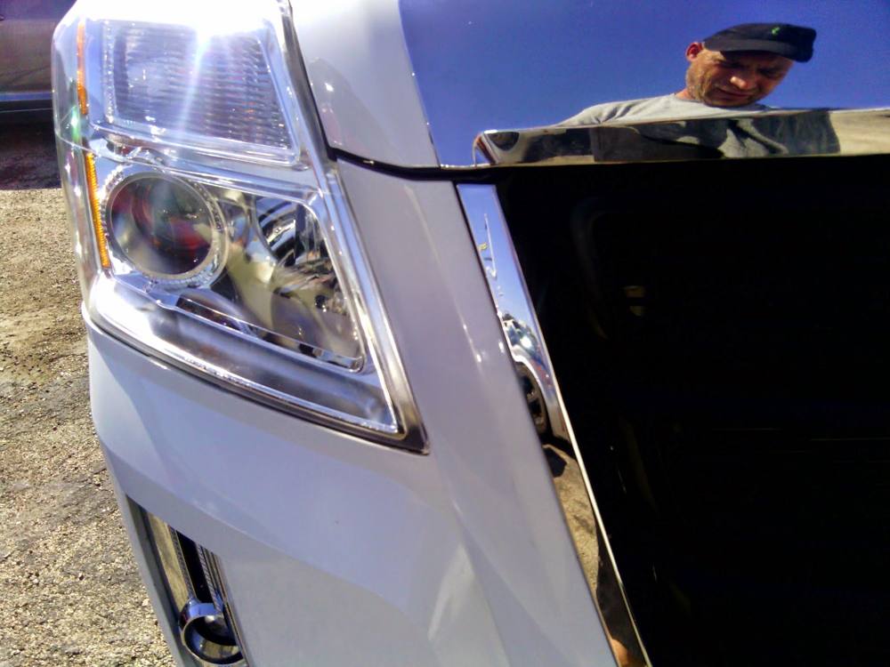 White pickup with the hood open during a mobile repair